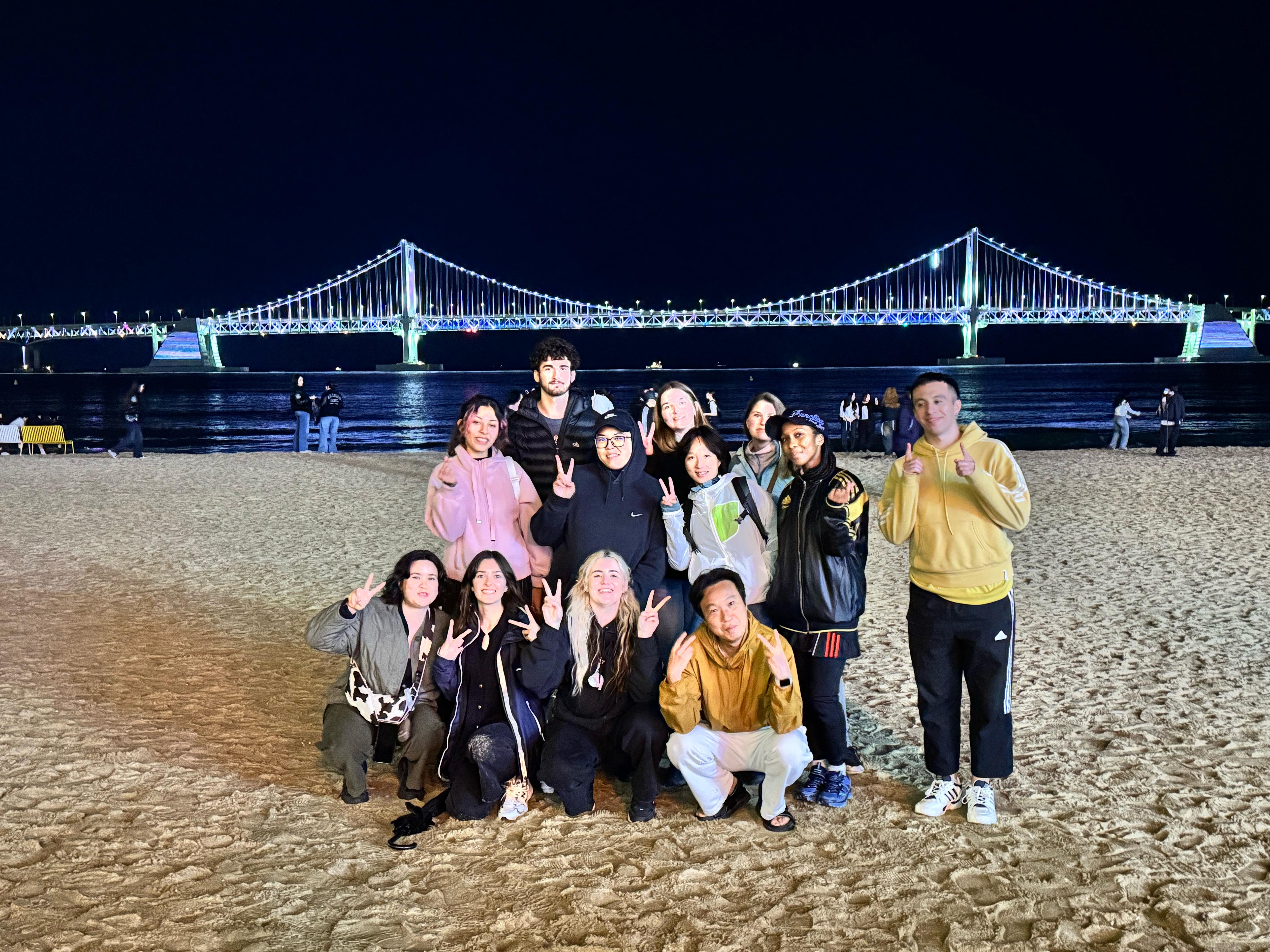 NOMAD LIVE community gathering at Busan beach with Gwangan Bridge